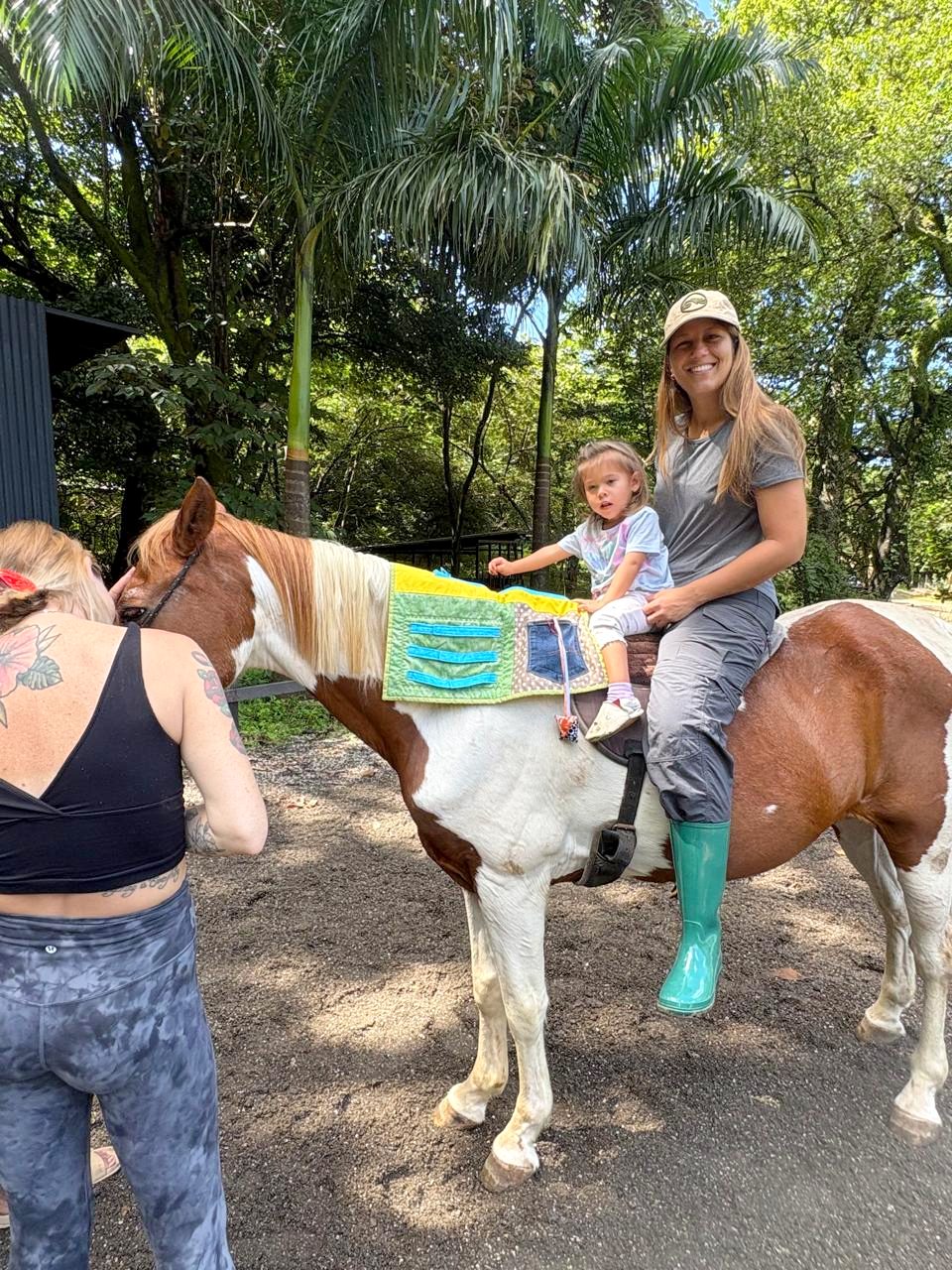 Toddler on a paint horse during an equine therapy session